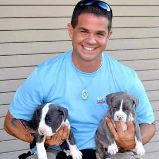 Rayfield poses with two of his favorite dogs that he trained.